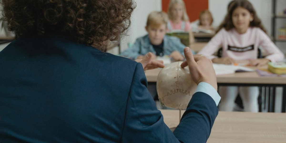 An educator actively teaching students about media literacy and critical thinking in a classroom setting.