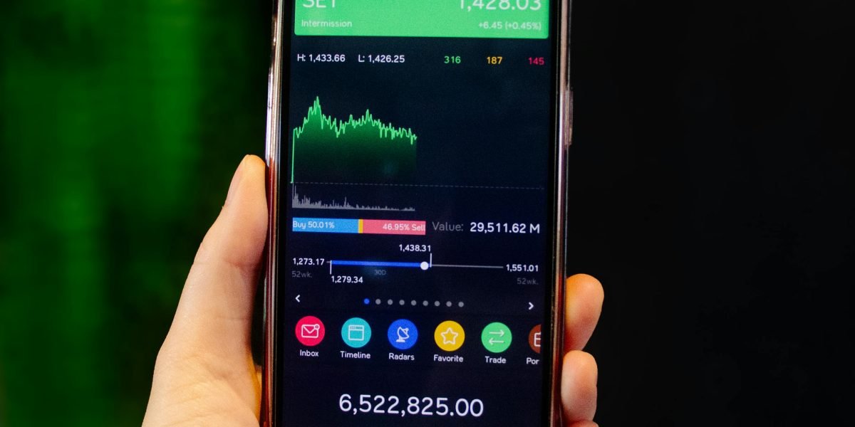 A person with a focused expression, carefully evaluating information displayed on their phone screen.