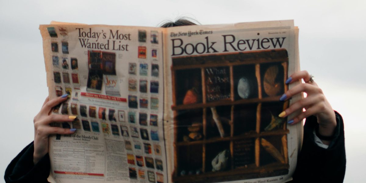 A person looking at various news sources, actively seeking different perspectives to broaden their understanding.