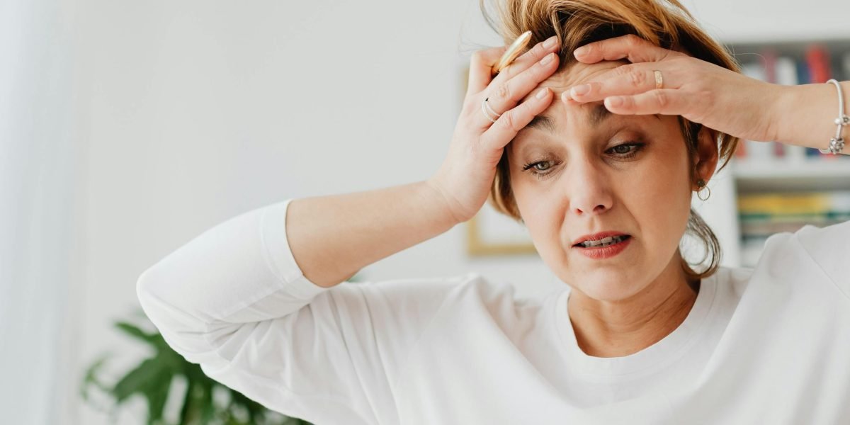 A person looking overwhelmed by multiple digital screens, illustrating the feeling of information overload and the challenge of maintaining focus.