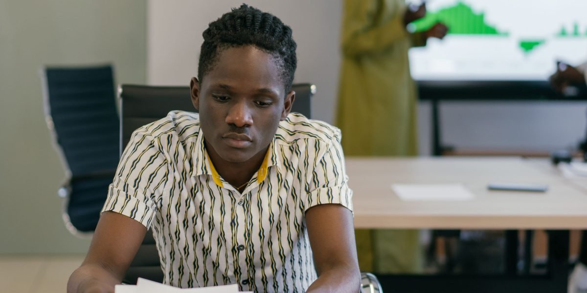 A person intently analyzing documents or news articles, applying a systematic framework.