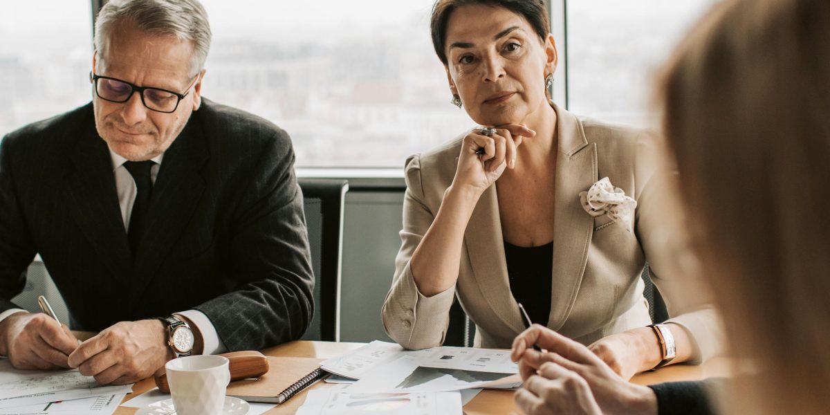 Professionals thoughtfully considering ethical implications and privacy concerns during data collection and reporting processes.