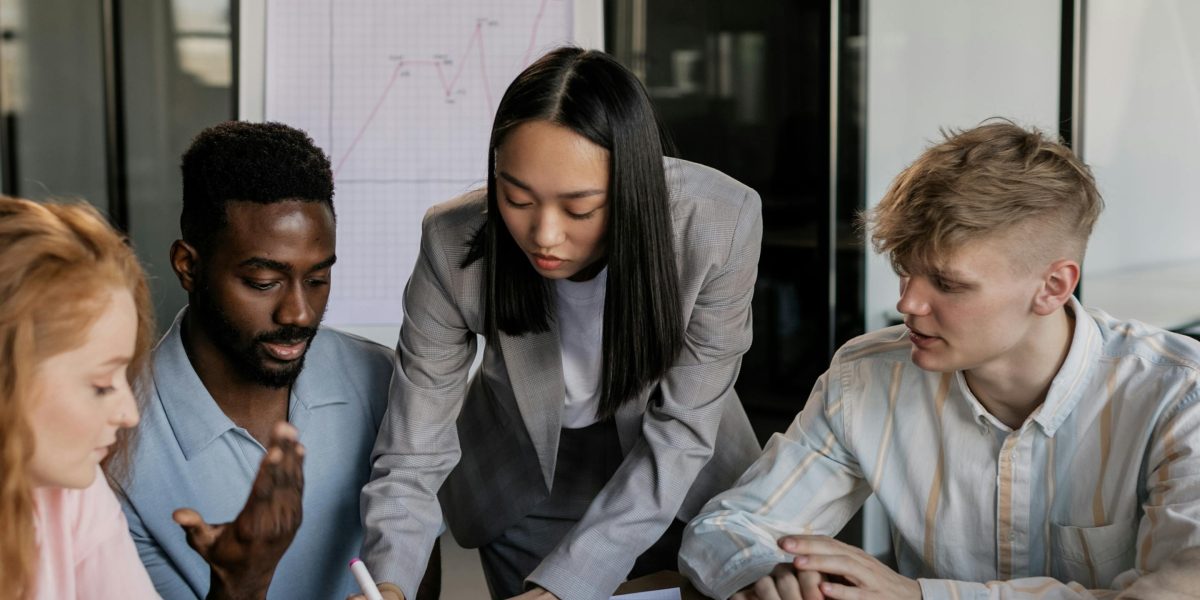 A team collaborates in a modern office setting, discussing marketing strategies and leveraging data insights for better targeting.