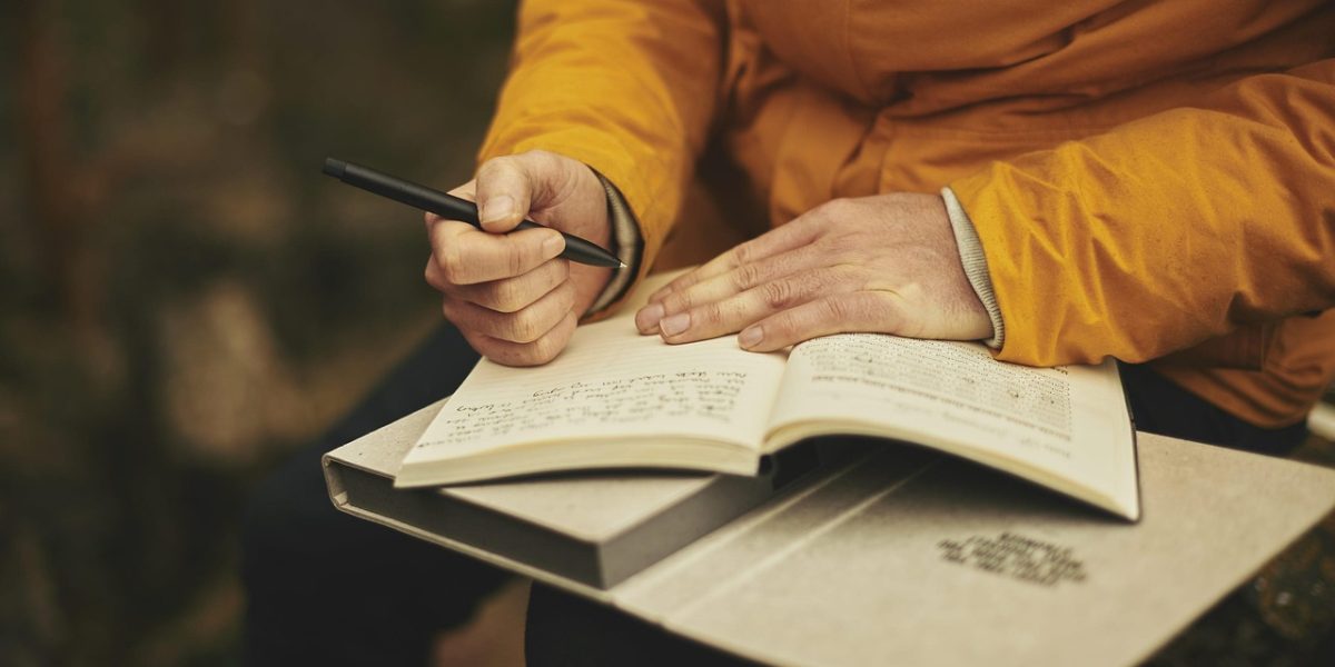 A person looks thoughtfully at a document, symbolizing the critical thinking and statistical literacy needed to interpret data and spot misinformation.