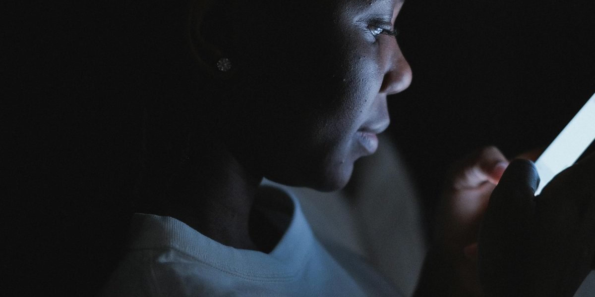 A person engaged in thoughtfully reading news, symbolizing the effort to understand information critically.