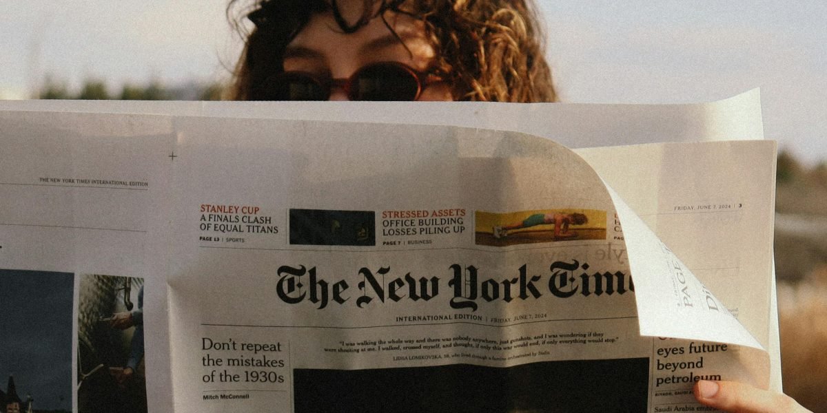 A person reading news on a digital device with a thoughtful, slightly skeptical expression, reflecting concerns about AI-generated content.