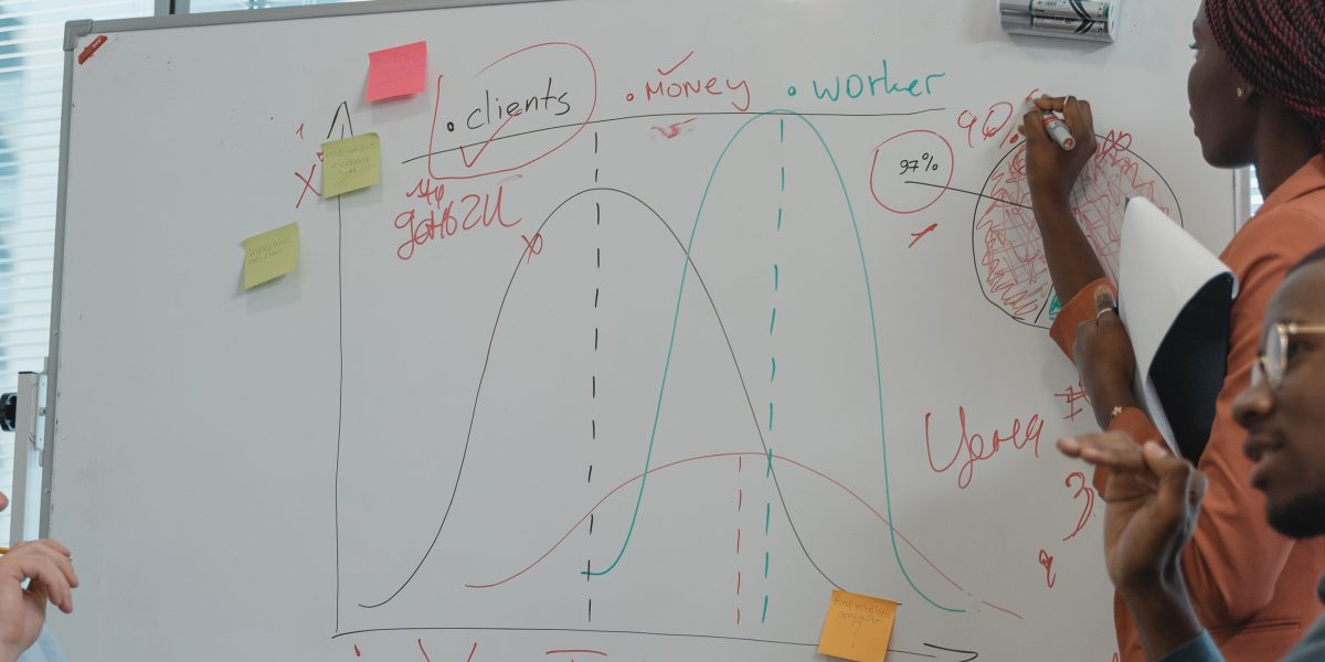 A team of professionals collaborating around a whiteboard, discussing strategies for integrating a new AI framework responsibly.