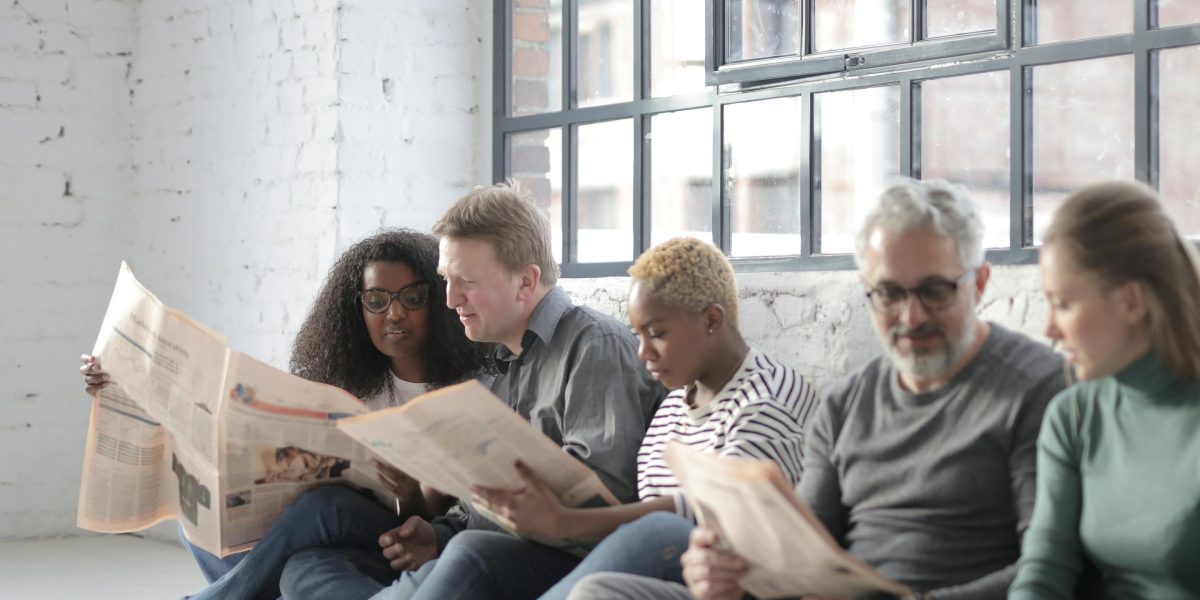 A group of people engaged in thoughtful discussion, symbolizing community efforts to understand local news.