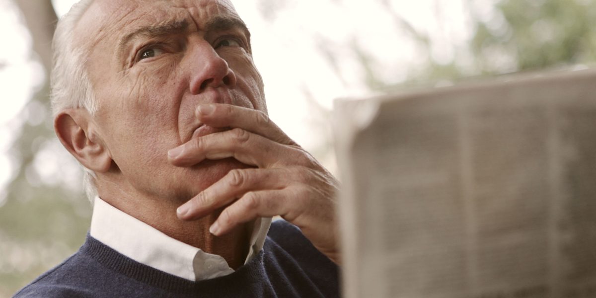A person absorbed in reading, reflecting on the fairness and balance of the news content.