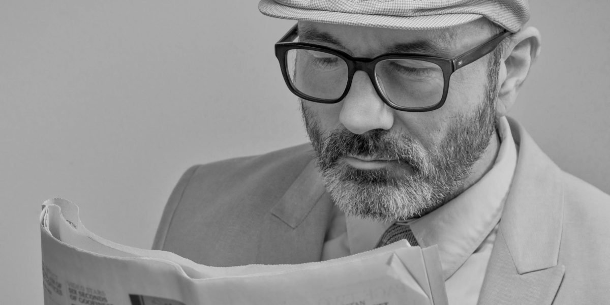 A person engaged in thoughtful reading, processing complex information.