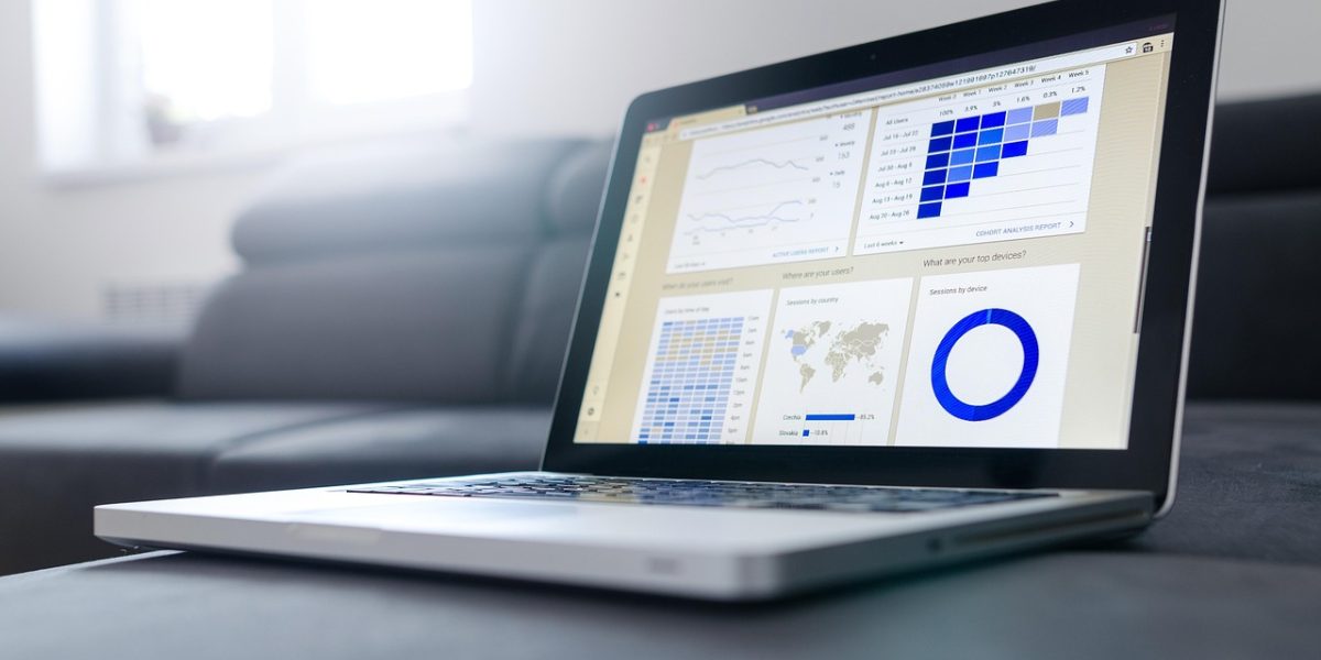 Business professionals analyzing a data dashboard with positive expressions, indicating successful measurement of trust-based marketing metrics.