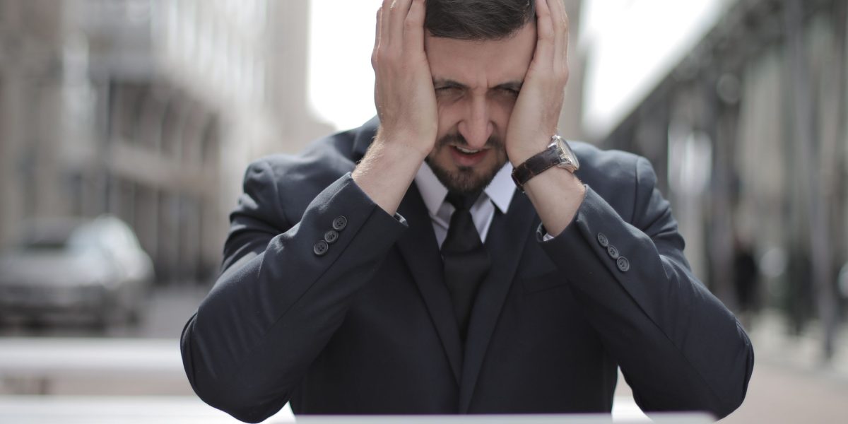 A person experiencing information overload, symbolizing the challenge of cutting through digital noise.
