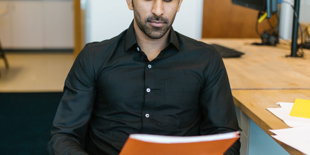 A person demonstrates focused attention while reading, symbolizing the detailed work involved in AI data labeling for media accuracy.
