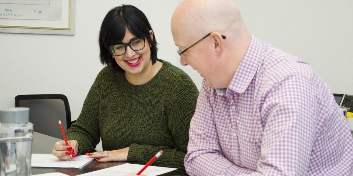 A group of people engaged in a discussion, symbolizing shared learning and critical evaluation of advertising techniques.