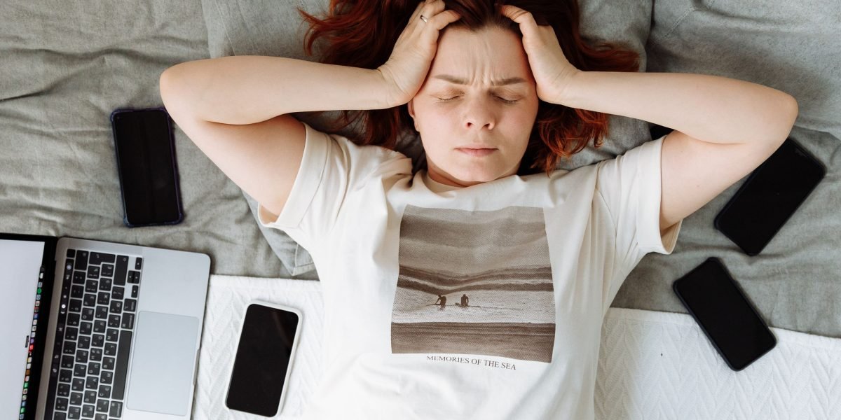 A person feeling overwhelmed by the constant barrage of digital information and ads vying for their attention.