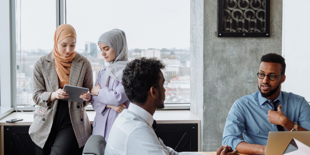 A diverse team collaborating in an office setting, illustrating the interdisciplinary nature of data analytics roles in media.