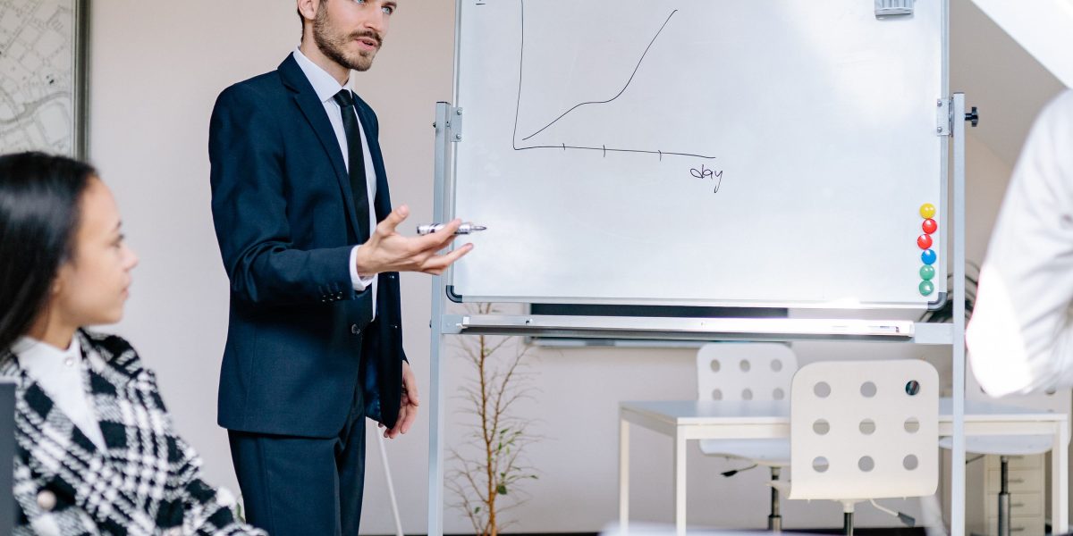 A person presenting their work on a whiteboard, demonstrating the importance of showcasing a strong portfolio in data analytics.